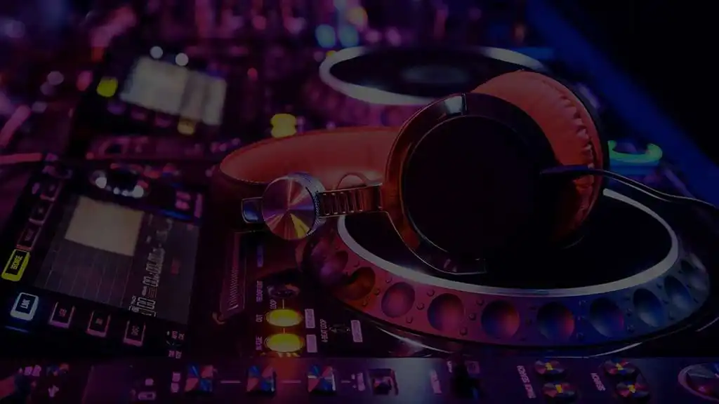 Pair of headphones sitting on some CDJs