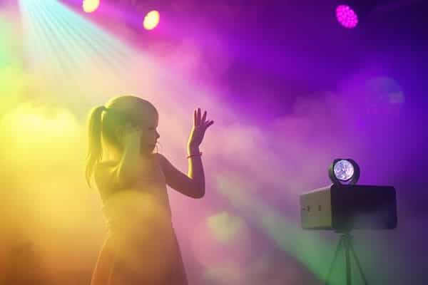 Little girl in the fog at a kids disco